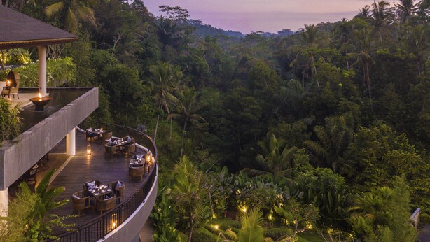 A resort with a curved deck, outdoor seating, and lush tropical vegetation. - Samsara Ubud (Payangan)