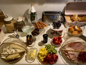 A table with various food items, including pastries, fruits, and condiments. - B&B Wine and Cooking Penedès (El Pla del Penedes)