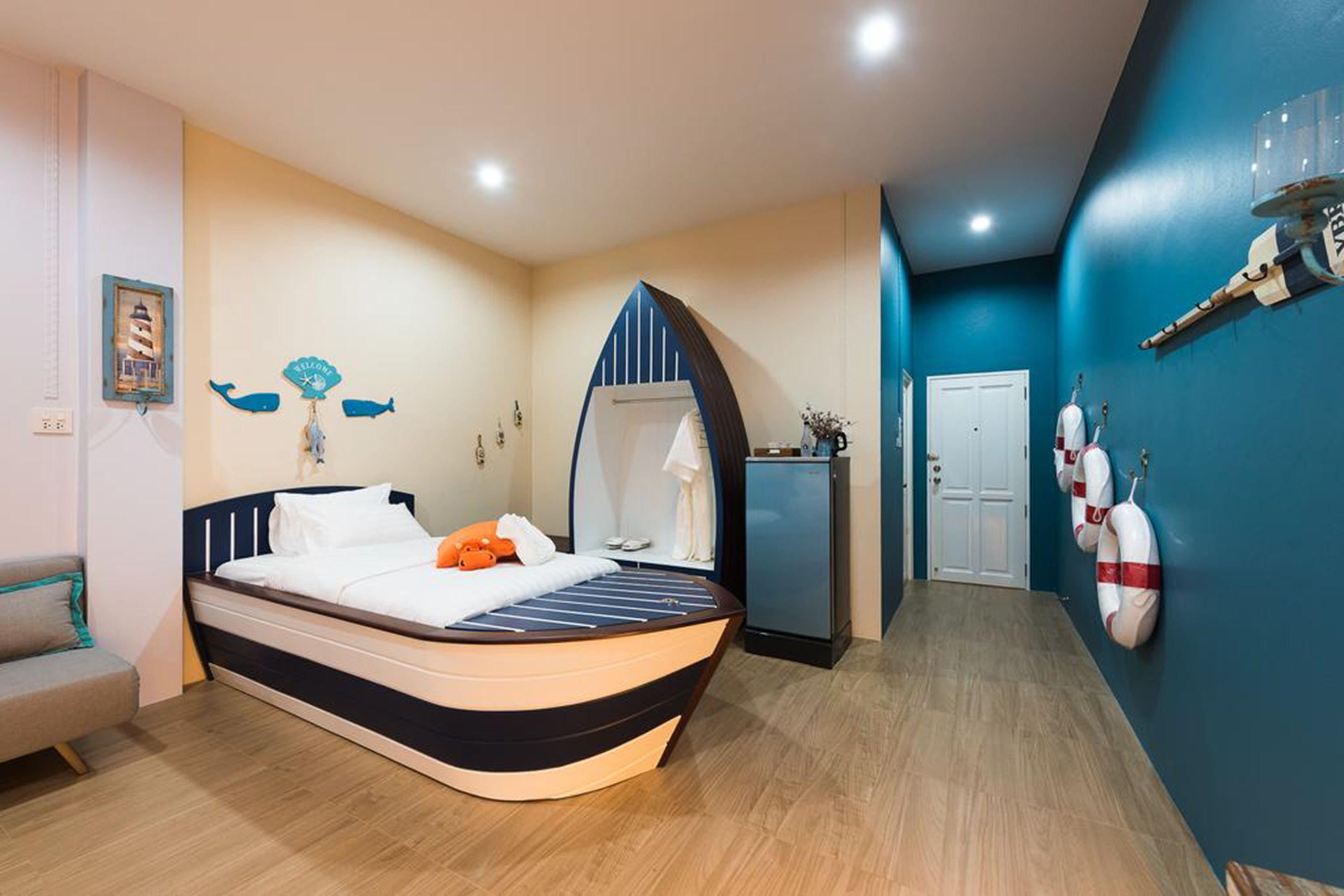 A bedroom with a bed, a dresser, a mirror, and a door.