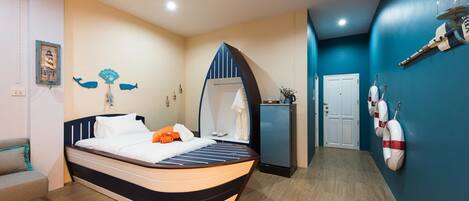 A bedroom with a bed, a dresser, a mirror, and a door.