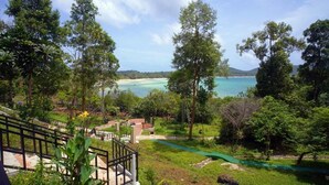 A view of a coastal area with a beach, greenery, and a small building. - Samloem Laguna Resort (Koh Rong Sanloem)