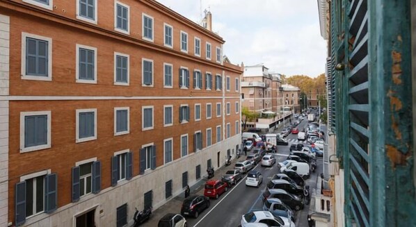 A multi-story building with a brick facade and multiple windows.