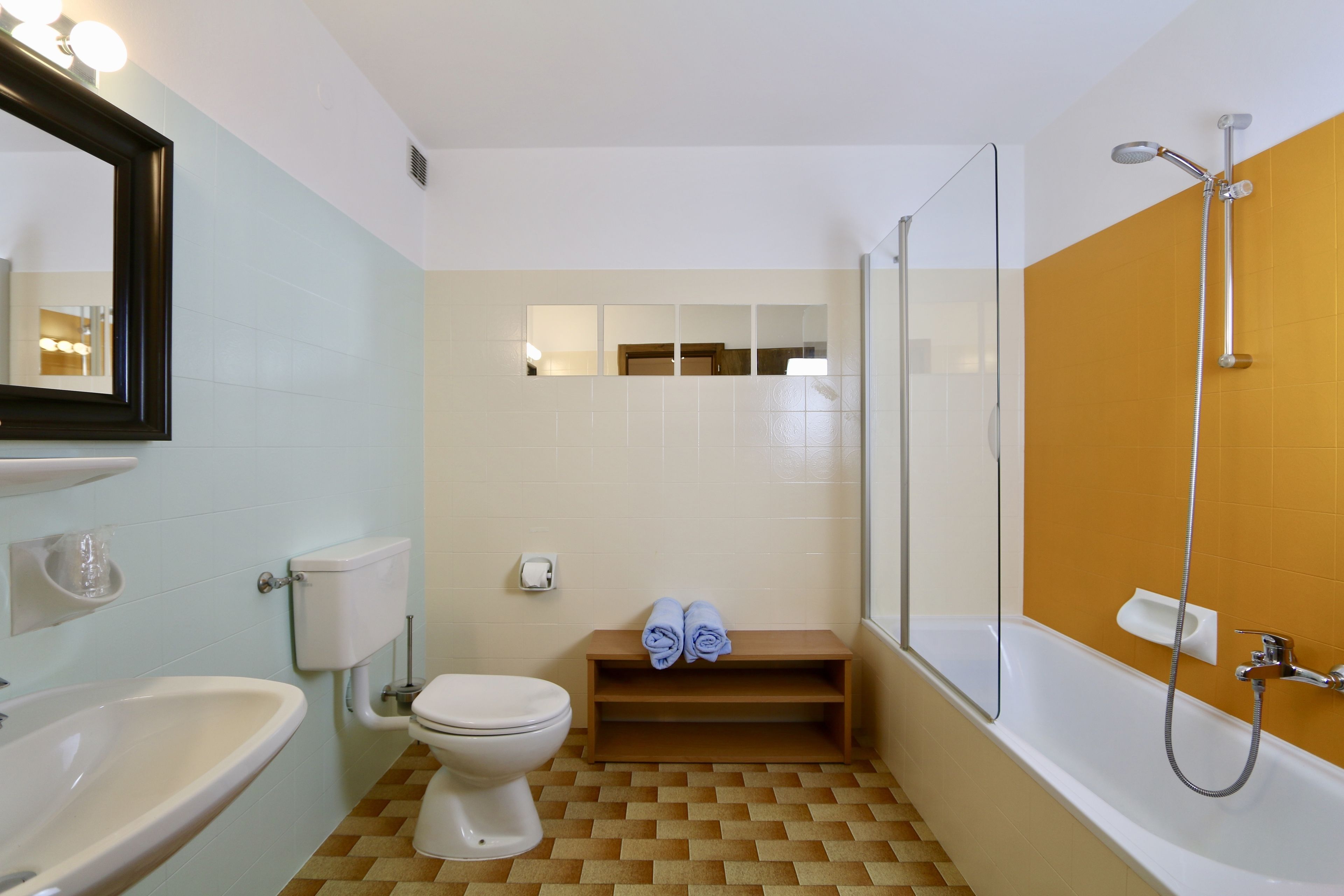 A bathroom with a sink, toilet, and shower.