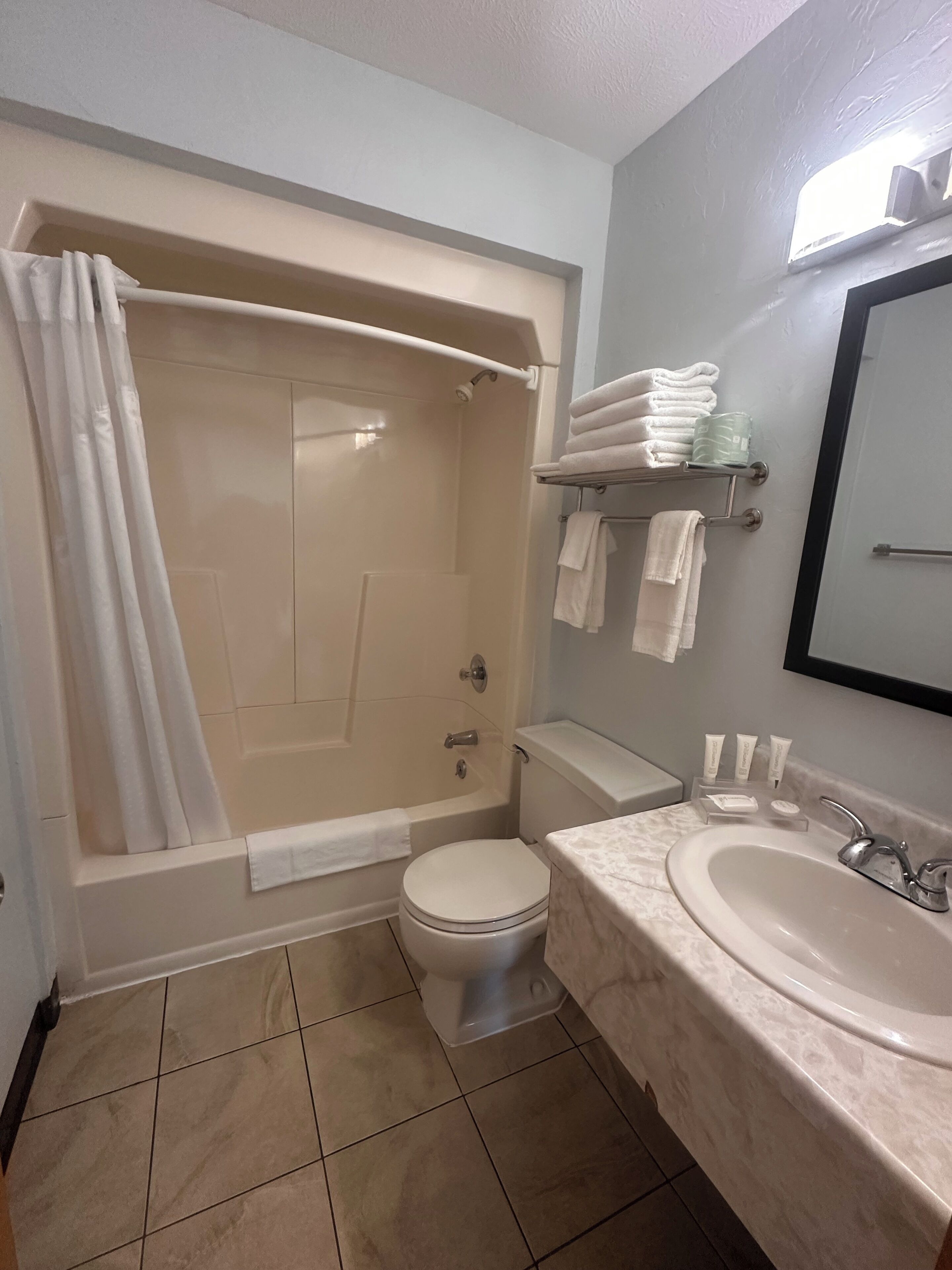 A bathroom with a bathtub, toilet, and sink.