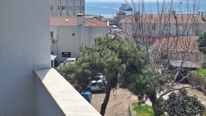 A view of a coastal cityscape with buildings, a bridge, and a ship in the distance. - Dilmac Hotel (Gallipoli)