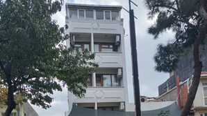 A hotel with a sign reading 'OTEL DILMAC' and a stone-paved entrance. - Dilmac Hotel (Gallipoli)