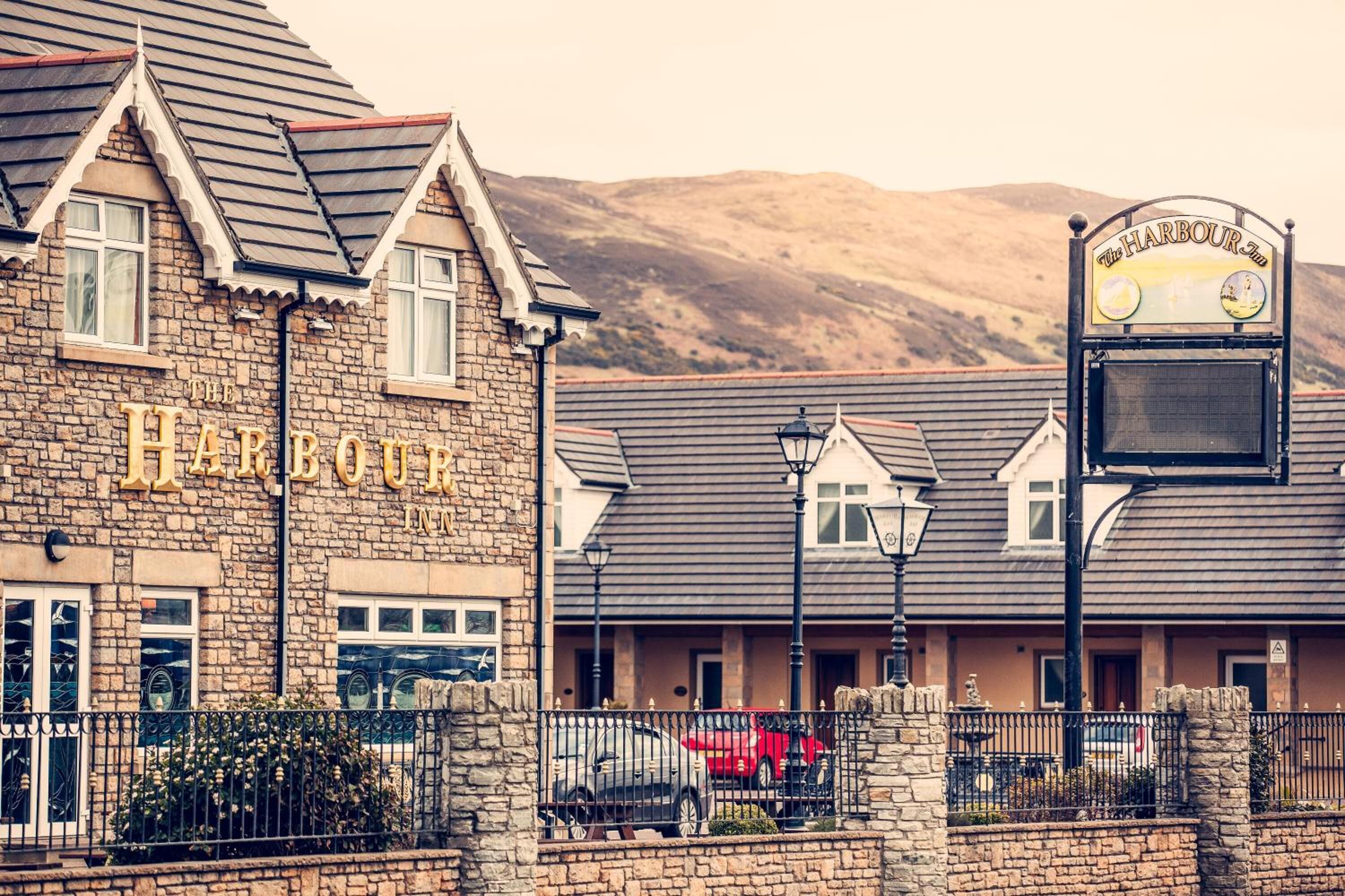 A stone building with a sign reading "The Harbour Inn."