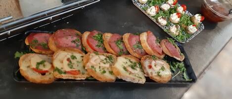 A display of various food items including bread, sandwiches, and appetizers.
