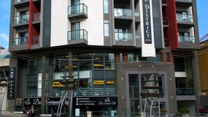 A modern hotel with multiple balconies, a restaurant, and a bar. - The District Hotel (St. Julian's)