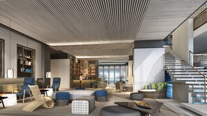 Amplia sala de estar con una escalera moderna, asientos cómodos y una gran estantería.