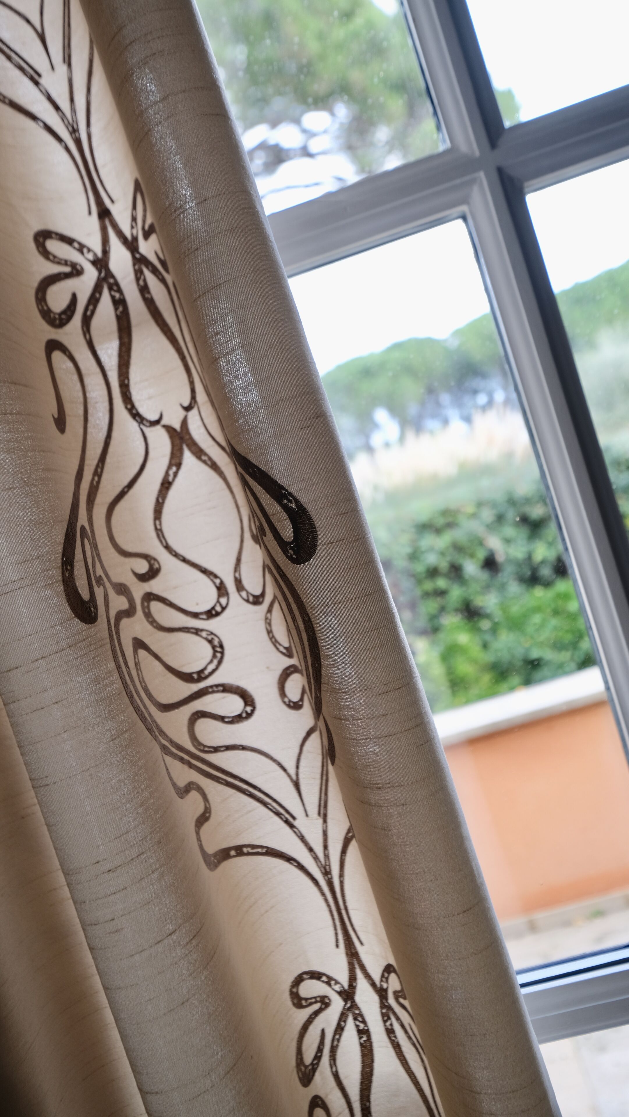 A window with a view of greenery outside.