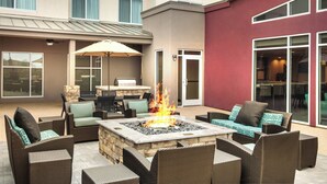An outdoor patio with wicker furniture, a fire pit, and a dining area. - Residence Inn by Marriott Dallas Plano/Richardson at Coit Rd (Plano)