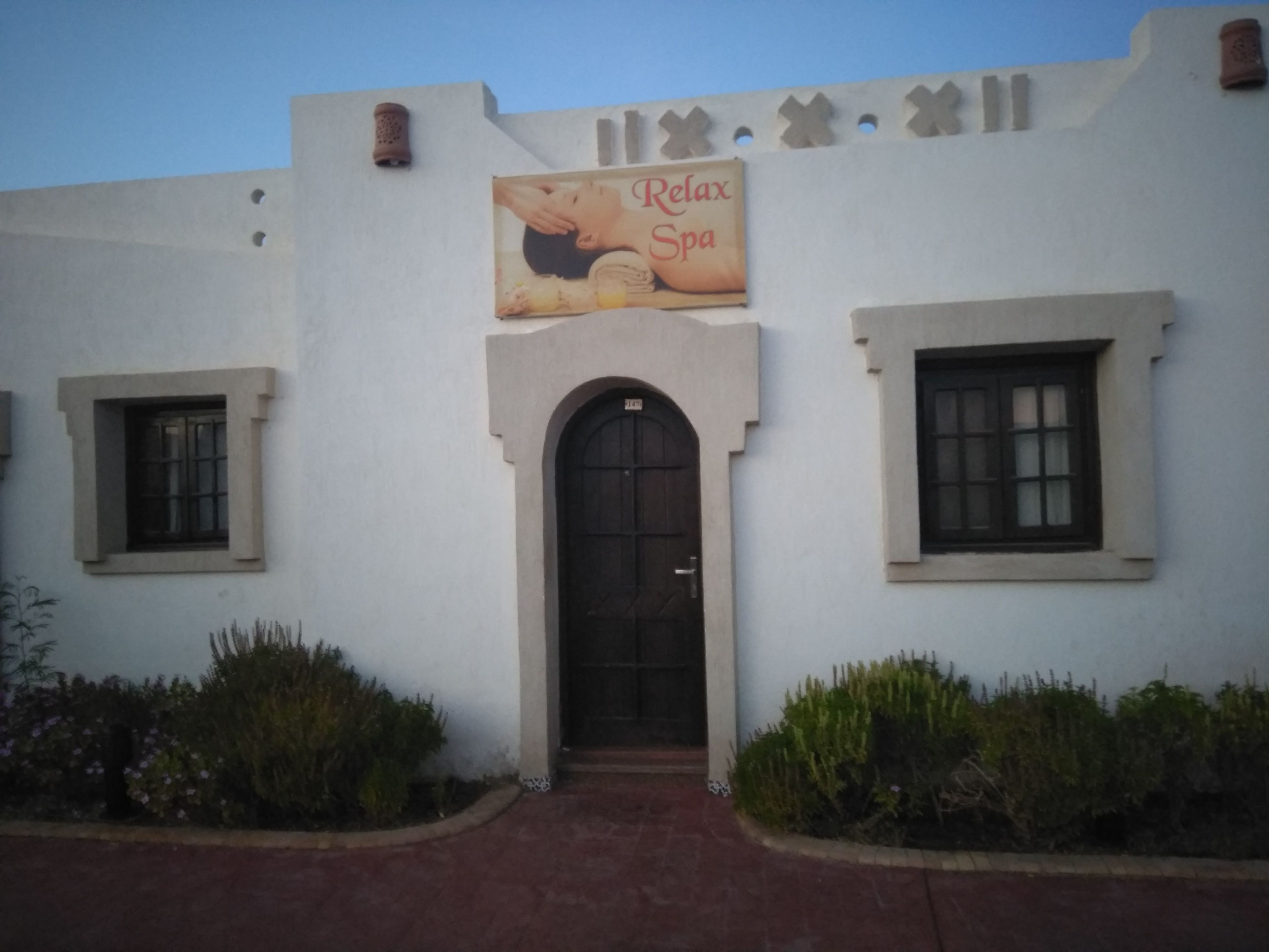 A building with a sign reading "Relax Spa" above the entrance.
