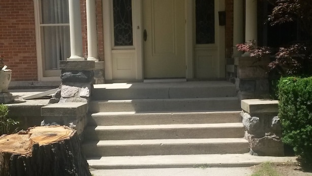 A two-story building with a front porch, a brick facade, and a number '30' above the door.