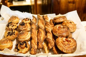 A variety of pastries arranged on a paper-lined tray.