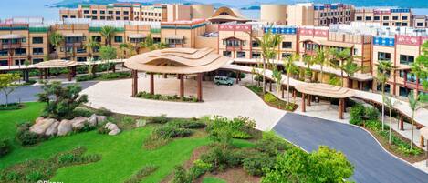 A resort with a central pavilion, multiple buildings, and a landscaped area with pathways and greenery.