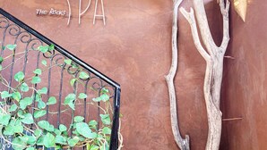 A spa sign with the word "SPA" and a decorative tree branch. - Kendwa Rocks Beach Hotel (Kendwa)
