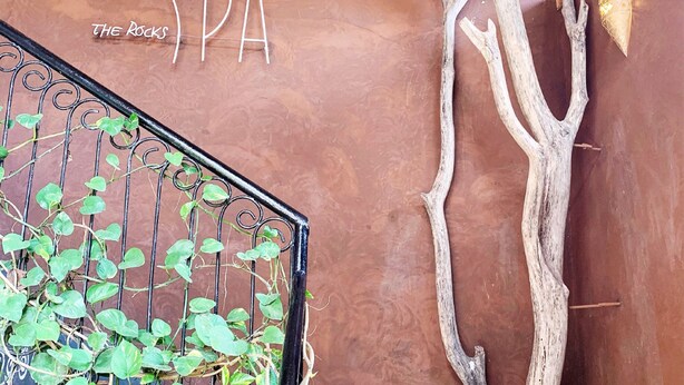 A spa sign with the word "SPA" and a decorative tree branch. - Kendwa Rocks Beach Hotel (Kendwa)