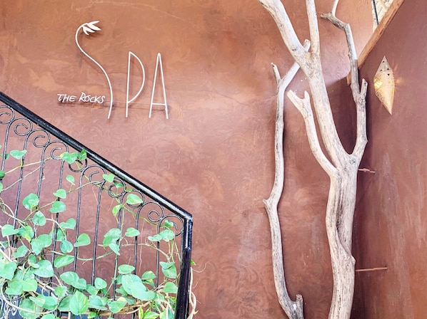 A spa sign with the word "SPA" and a decorative tree branch. - Kendwa Rocks Beach Hotel (Kendwa)