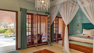 A room with a bed, a bench, a ladder, and a view of the outside.