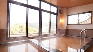 A steam room with large windows and a wooden ceiling. - Ikijimaso (Iki)