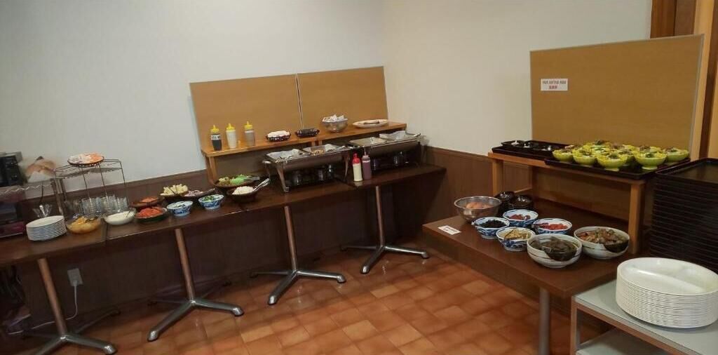 A buffet setup with various food items and condiments.