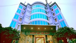 A multi-story building with a prominent entrance and signage. - Van Giang Hotel (Ninh Binh)