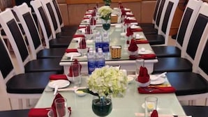 A conference room with a long table set for a meeting. - Van Giang Hotel (Ninh Binh)