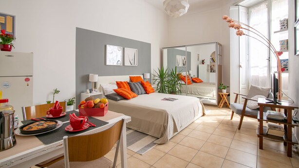 Une chambre d’hôtel moderne équipée d’un lit, d’une table de chevet et d’un coin repas.