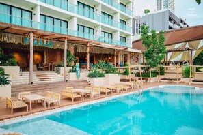 A hotel with a pool area, outdoor seating, and a covered bar area. - Zand Morada Pattaya (Pattaya)