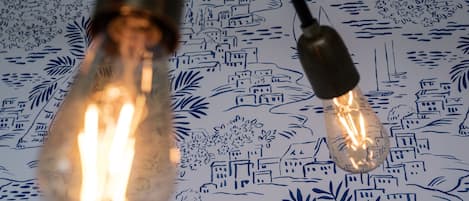 Two light bulbs with filament bulbs on a patterned surface.