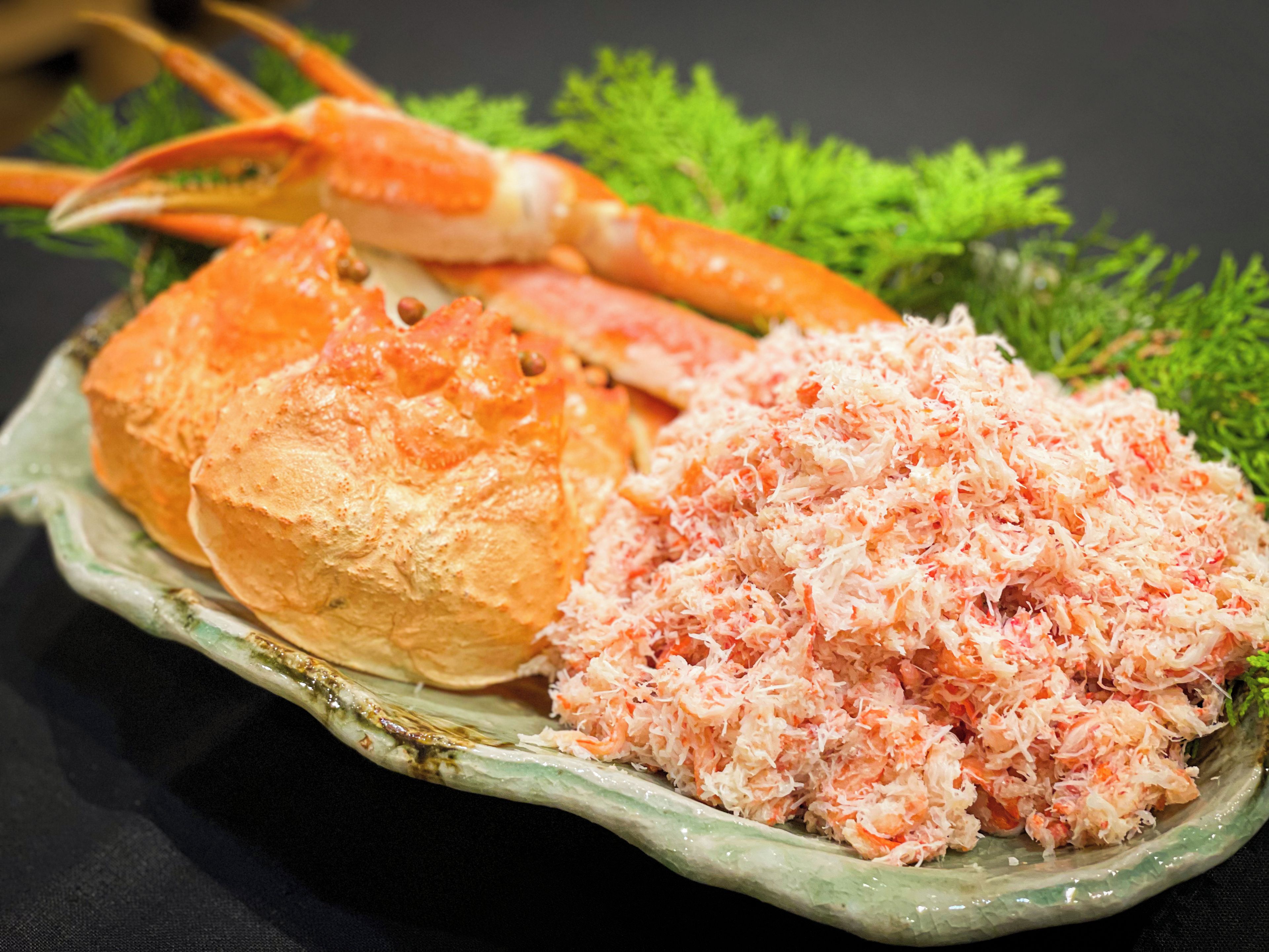 A plate with crab meat and a crab leg.