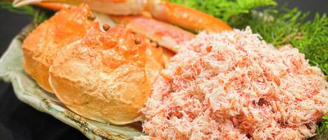 A plate with crab meat and a crab leg.