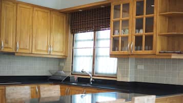 Deluxe 3-Bedroom Villa | Private kitchen | Full-size fridge, microwave, coffee/tea maker