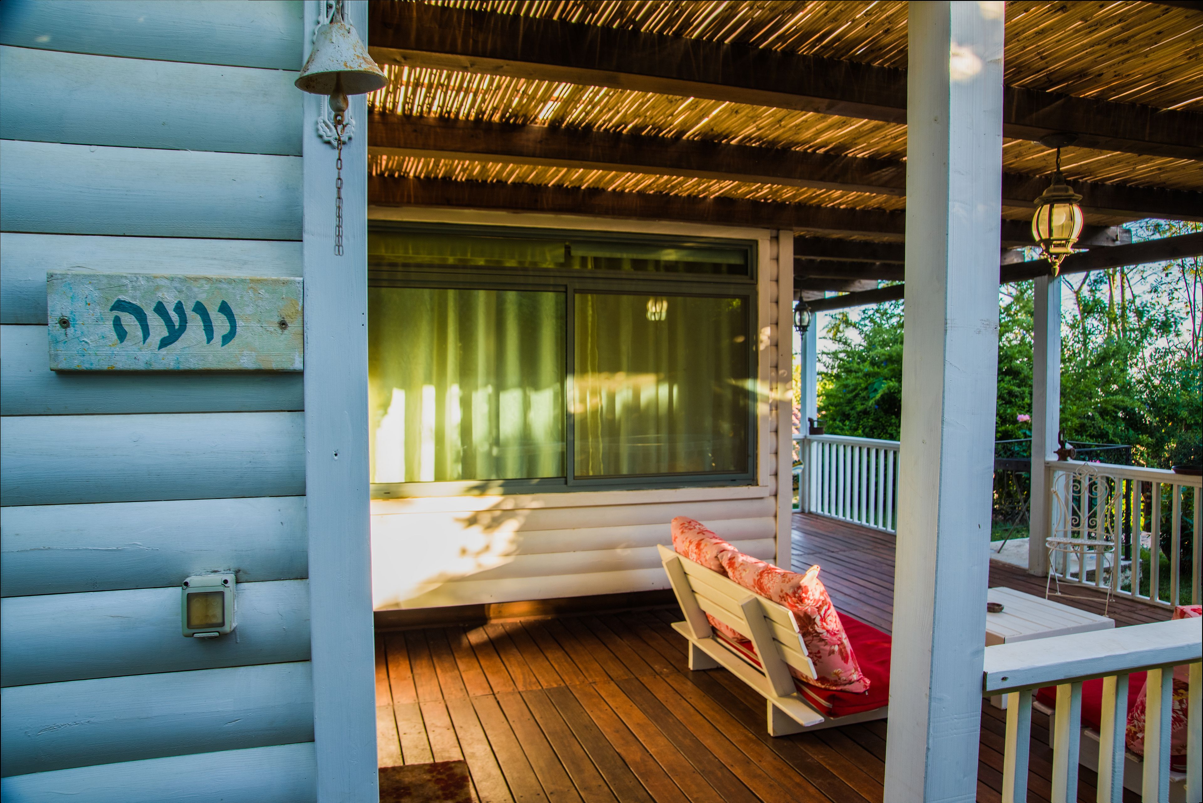 A wooden deck with a bench and a railing.