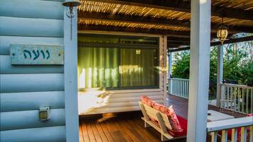 A wooden deck with a bench and a railing.