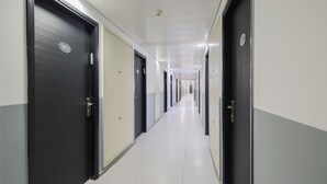 A long, narrow hallway with doors on both sides, leading to individual rooms. - Soho Eilat (Eilat)