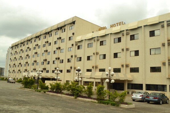 A multi-story hotel with a flat facade, numerous windows, and air conditioning units. - Afri Hotel (Abuja)