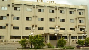 A multi-story building with the sign "AFRI HOTEL" at the top.