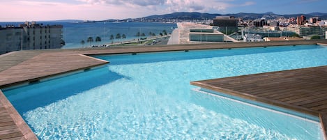 Outdoor pool, open 10:30 AM to 6:30 PM, pool umbrellas, pool loungers