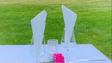 A table set outdoors with a view of a lake and trees.