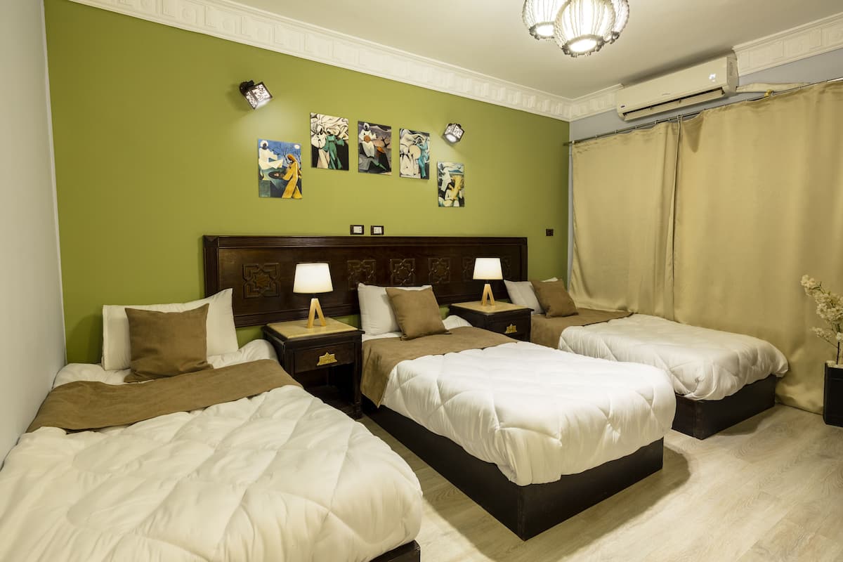 Deluxe Triple Room, City View | Minibar, in-room safe, desk, blackout drapes