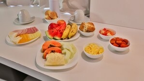 A breakfast buffet with various fruits, pastries, and a coffee station. - Nobile Inn Pampulha (Belo Horizonte)