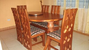 A dining table with six chairs, each with a patterned cushion.