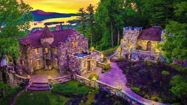 A castle-like structure with stone walls, a central courtyard, and a bridge leading to a larger building. - HIGHLANDS CASTLE overlooking Lake George.. plus 2 other Castles! (Bolton Landing)