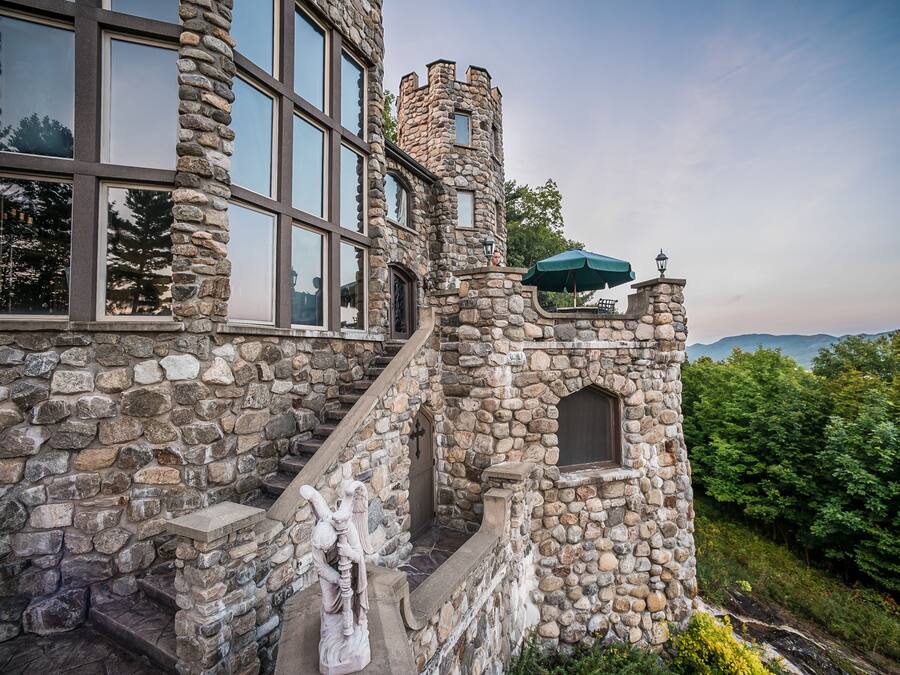 A stone building with large windows and a tower.