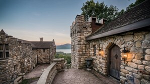 A stone building with a wooden door and a stone archway. - HIGHLANDS CASTLE overlooking Lake George.. plus 2 other Castles! (Bolton Landing)