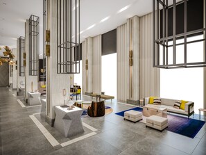 A spacious, modern living area with a sofa, ottomans, and a coffee table. - Summit Galleria Cebu (Cebu City)