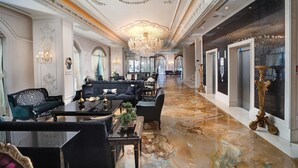 Un hall d’hôtel luxueux, agrémenté de lustres somptueux, de meubles élégants et d’un sol en marbre.