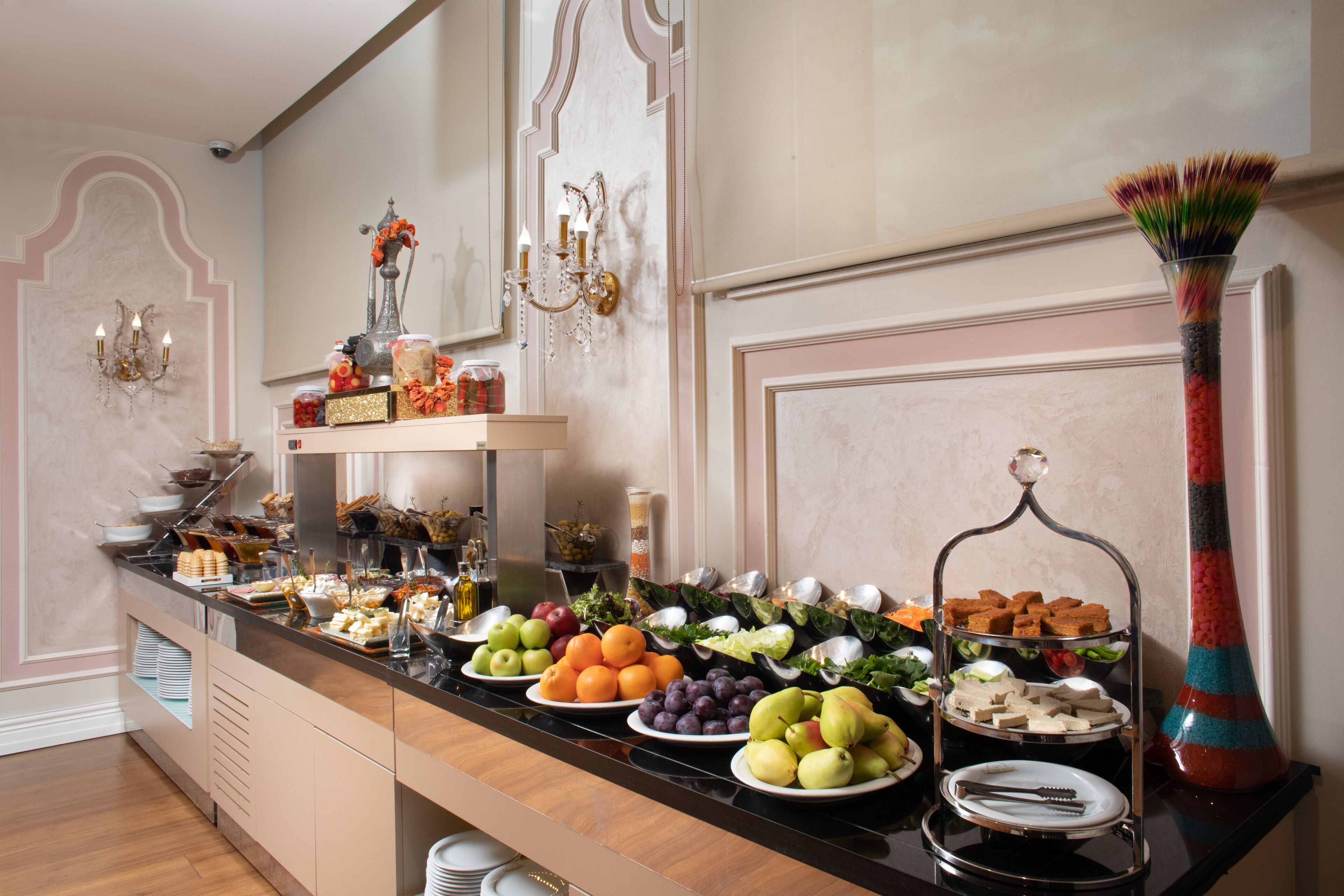 A buffet with various food items and a decorative vase.